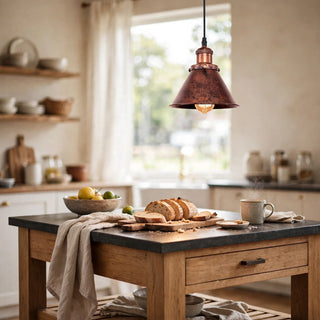 Ramelle copper pendant glowing over a kitchen island