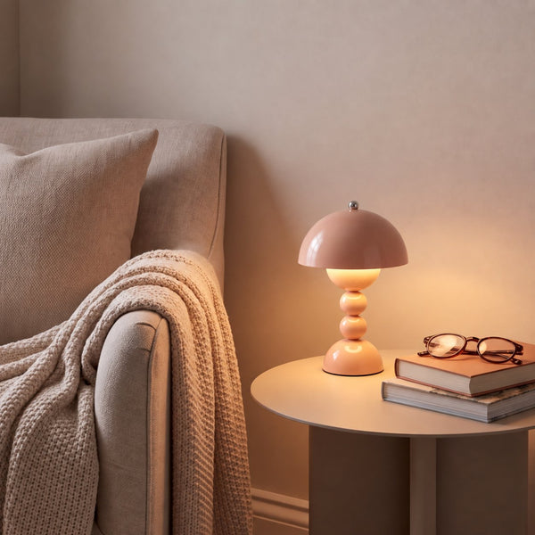 Cressa Beige Red cordless table lamp in a reading nook setting, styled to the listed compact size